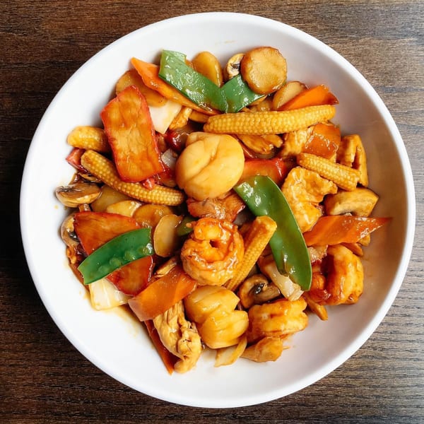 Howard Wang's Preston Hollow Asian dish with shrimp, scallops, chicken, baby corn, and vegetables.
